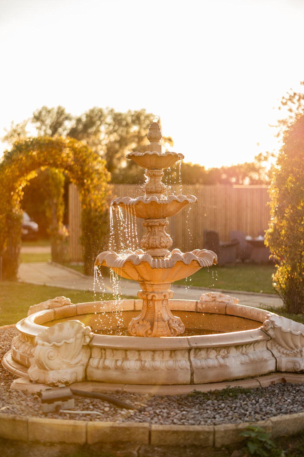 Garden fountain at golden sunset